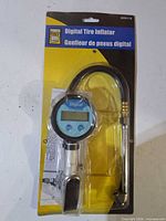 Front view of packaged digital tire inflator showing display and hose