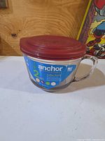 Full view of glass batter bowl with label and handle