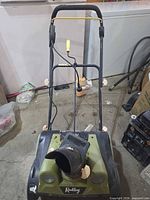 Front view showing chute, brand logo, handle