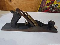 Right side view of full hand plane including knob, lever cap, tote