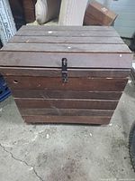 Front view closed showing slat construction and metal hasp