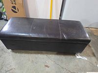 Closed ottoman showing exterior vinyl surface and overall shape