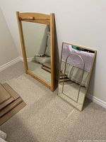 Both mirrors leaning against wall