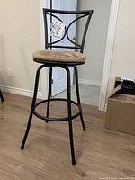 Full view of bar stool showing metal frame and seat