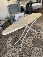 Full view of ironing board set up on floor