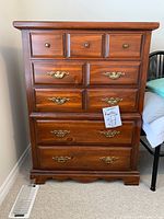 Front view showing all nine drawers and hardware