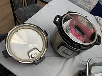 Main unit with lid removed showing accessories inside and separate underside of lid