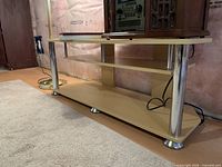 Side view showing light maple finish, chrome legs, lower shelf