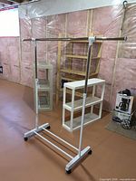 Overall view of adjustable clothing rack and three shelving units