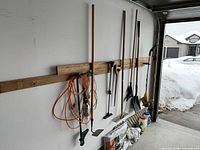 All tools hanging on wall rail in garage showing full length and heads