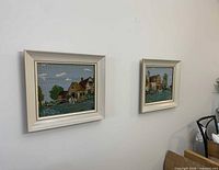 Pair of framed needlepoints on wall