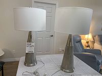 Front view of both brushed nickel table lamps with shades