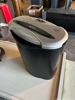 Shredder showing black basket and silver control top