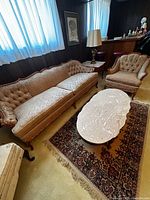Sofa, armchair, coffee table and rug visible; focus on furniture set
