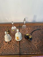 Group shot of all seven bells on table