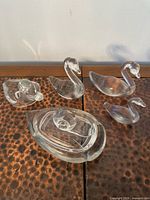 Group view of all five clear glass pieces on tabletop