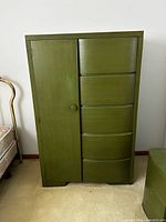 Front view of olive green armoire