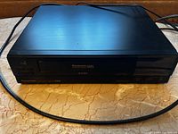 Front view of Panasonic Omnivision VHS VCR with tape slot and branding