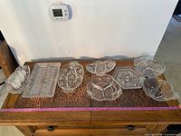 Overview of all pressed glass pieces on table