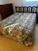 Complete queen bed showing headboard, mattress, comforter
