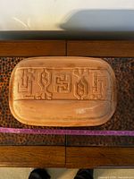 Top view of terracotta lid with geometric pattern