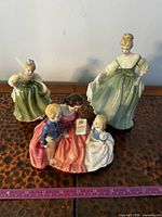 Overall view of the three Royal Doulton figurines arranged together
