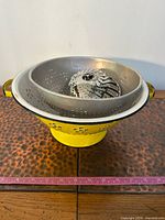 All three pieces stacked: yellow colander base, silver colander, steamer basket