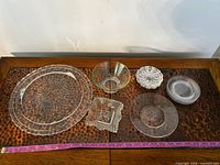Top view of all six clear pressed glass items laid out