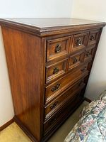 Oblique view of full tall chest showing finish, drawer arrangement and hardware