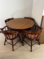 Round dining table with four chairs arranged