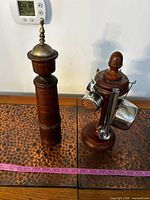 Pepper mill and wooden stand with measuring sets displayed together