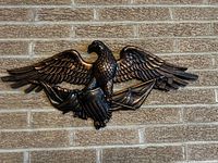 Front view of resin eagle wall plaque mounted on brick wall