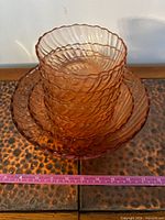 Stacked view showing six small bowls nested in large bowl