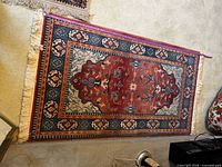 Full view of one Persian-style rug showing color and size