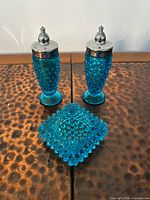 Front view of both shakers and dish displaying colour and pattern