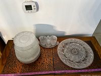 overview of stacked plates, condiment set and platter on table