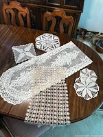 Six crochet pieces laid out on table