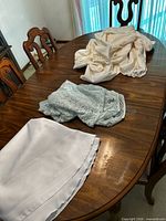 Three folded table linens on dining table