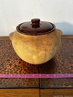 Front view of stoneware bean pot with lid in place showing exterior color and form
