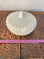 covered candy dish front view with ruler for scale