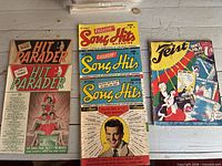 Front covers of one Hit Parader, three Song Hits, one Feist displayed