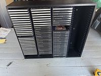 Front view of black CD stand filled with CDs