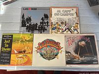 First image shows six LPs including CJCL 1430, Al Capp, Disney, Beatles, War of the Worlds