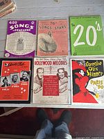 Six representative covers of songbooks and booklets laid out