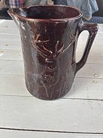 Front view showing deer relief and overall glaze