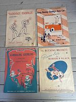 Four representative sheet music covers laid out