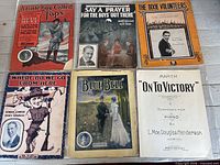 First set of six sheet music covers laid out on surface