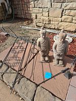 Overall view showing two warrior statues, trellis hanger and stakes
