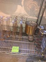 Full lot on shelf: three patterns of champagne flutes, ice bucket, ribbed pitcher, stacked tumblers