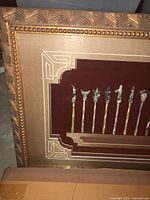 Corner detail showing frame pattern and mounted arrowheads